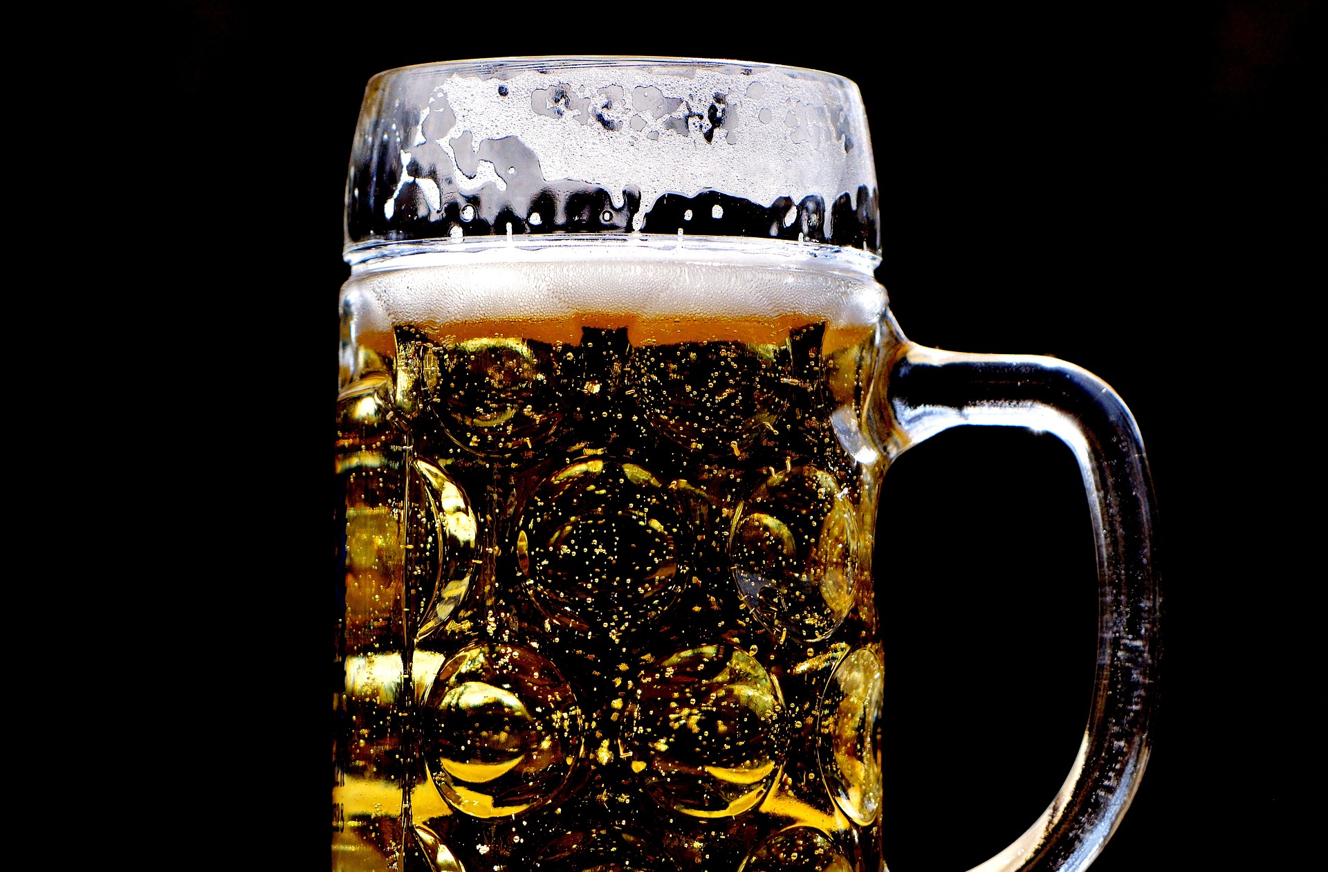 a beer glass along a black background