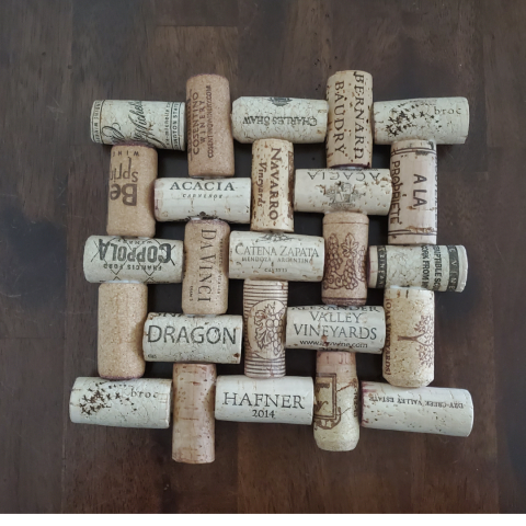 A herringbone-pattern trivet made out of wine corks of different shades.