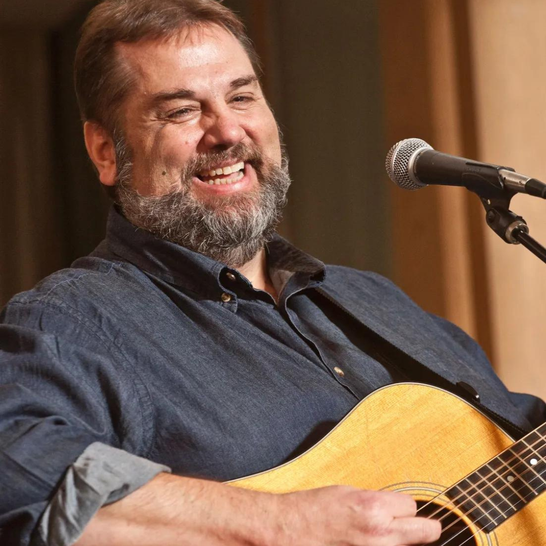 Portrait of Matt Watroba playing guitar